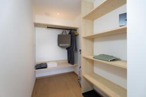 a tiny house with a hallway with wooden shelves at Alpin Chalet Trinkl - adults only ab 16 Jahren in Bad Wiessee