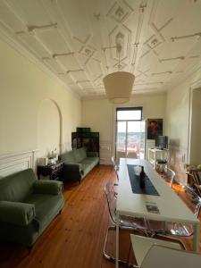 a living room with a couch and a table at Casa da Carqueja in Coimbra