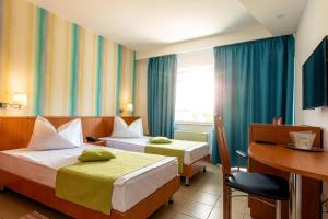 Postel nebo postele na pokoji v ubytování Hotel Apollo