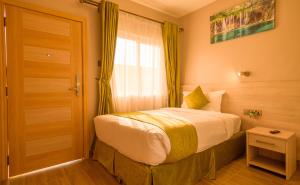 Postel nebo postele na pokoji v ubytování Abai Lodges & Spa