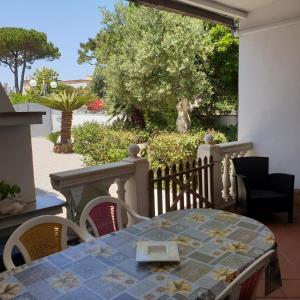 un tavolo e sedie su una veranda con vista sul giardino di Villa Nausicaa San Felice Circeo a San Felice Circeo