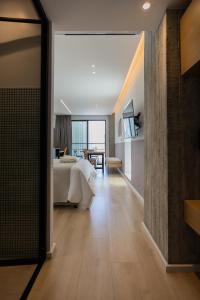a large bedroom with a bed and a table at Alinea Urban Saripolou Square in Limassol