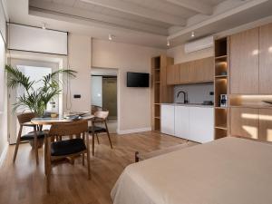 a kitchen and living room with a table in a room at Lithinon Luxury Suites Old Town Chania free on-site Parking in Chania