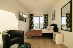 Televízia a/alebo spoločenská miestnosť v ubytovaní BALTICUS APARTAMENT