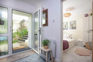 a bedroom with a bed and a sliding glass door at Brixham Breeze in Brixham