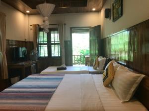 a large bedroom with two beds and a television at Phu Quoc Pomelo Garden in Phu Quoc +42 photos