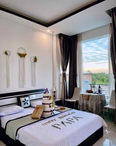 a bedroom with a bed with a cake on it at Sao Khue Riverside Hotel & Coffee in Sa Ðéc +216 photos
