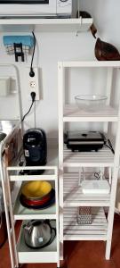 - deux étagères blanches dans une cuisine avec des produits alimentaires dans l'établissement Casa Pescado y mariposas, à Arrecife
