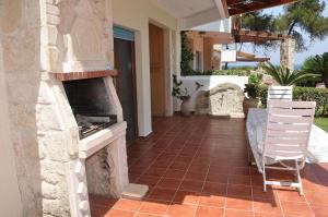 A balcony or terrace at Yades elegant villa 2 minutes away from the beach