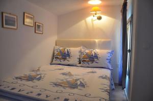 a bedroom with a bed with two pillows on it at Yades elegant villa 2 minutes away from the beach in Kallithea Halkidikis