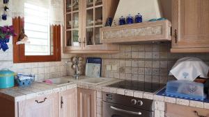A kitchen or kitchenette at Yades elegant villa 2 minutes away from the beach