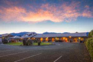 a building with a parking lot in front of it at Mohua Motels in Takaka