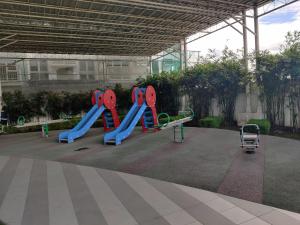 a playground in a building with a slide and aroller at Abreeza Condo T2-2820 in Davao City