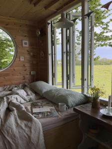 a bed in a room with a window at Treehouse escape in Kværndrup
