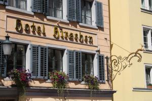 a building with windows and flowers on it at Hotel Hirschen in Zürich