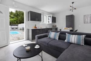 a living room with a couch and a table at Summer Stories Pool Villa in Potamós