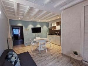 a living room with a table and a kitchen at Torino Vacancy San Tommaso Suite in Turin