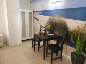 a dining room with a black table and chairs at Pension zum Lichtenberger in Berlin