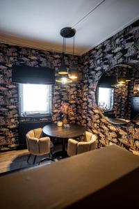 a dining room with a table and chairs and a mirror at Cosy Aquarium for a couple or friends in Groningen