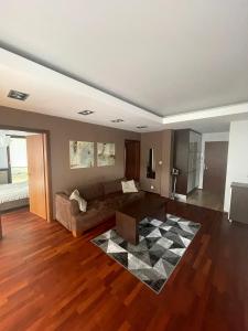 a living room with a couch and a checkered rug at Golden Sun Apartments in Mielno