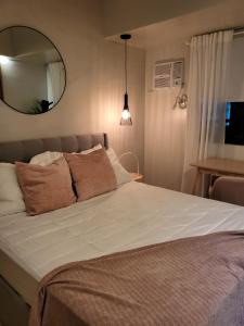 a bedroom with a large bed with a mirror at Kasa Bae in Tagaytay