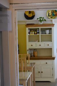 a kitchen with a hutch and a table in a room at St Marguerite in Paignton