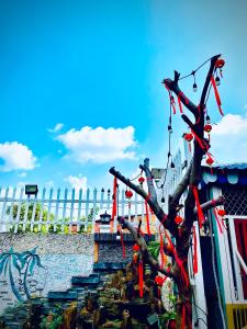 a tree with redbons on it next to some stairs at Hotel Sao Khuê in Sa Ðéc