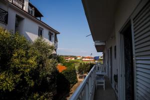 a view from a balcony of a house at Blue Theros Apartments in Paralia Dionysiou