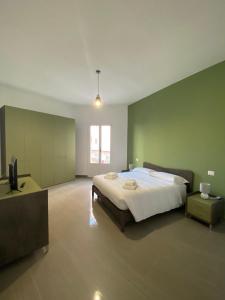 a large bedroom with a large bed and a television at Naturelais in Monopoli
