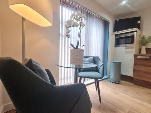 a living room with a table and two chairs and a couch at Sheffield City Centre Studio in Sheffield +3 photos