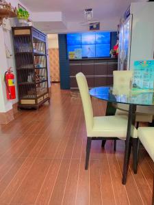 a dining room with a glass table and chairs at Sunshine Hotel in Hua Hin