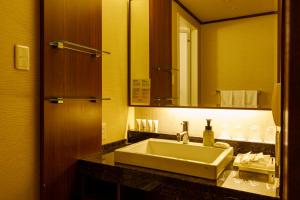 a bathroom with a sink and a mirror at ANA Holiday Inn Kanazawa Sky by IHG in Kanazawa