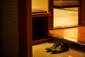 a pair of shoes sitting on the floor next to a door at ANA Holiday Inn Kanazawa Sky by IHG in Kanazawa
