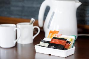 a white container filled with books on a table with cups at ANA Holiday Inn Kanazawa Sky by IHG in Kanazawa
