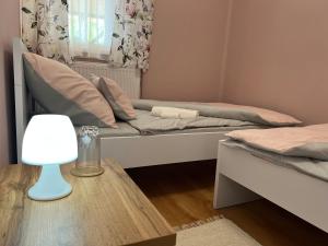 A bed or beds in a room at Négy Évszak Vendégház