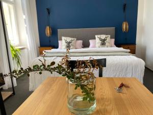 a bedroom with a bed with a vase on a table at Apartment Stará Pošta in Hartmanice