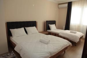 Ein Bett oder Betten in einem Zimmer der Unterkunft Kıvanç Residence