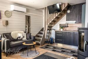 a small living room with a couch and a kitchen at Aava Sky Village in Aavasaksa