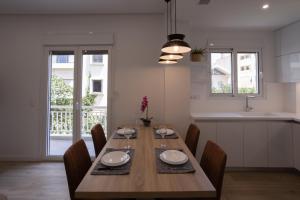 - une salle à manger avec une table et des chaises en bois dans l'établissement Athens Riviera, à Athènes