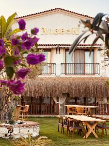a restaurant with tables and chairs in front of a building at Albeon Luxury Hotel - Alacatı in Alaçatı