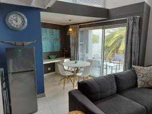 a living room with a couch and a table at The Well Dressed Loft in Walmer