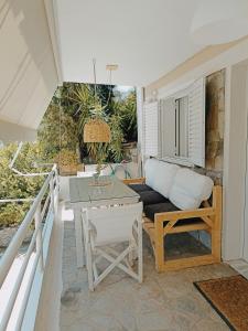 a living room with a couch and a table at Heras Garden in Vasiliki