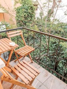 a wooden chair and a table on a balcony at 1453Apartments in Istanbul