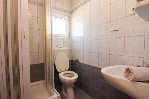 a bathroom with a toilet and a sink at Apartments City Center Dekanić in Krk