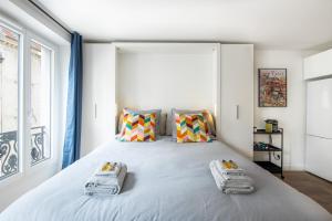 a bedroom with a large bed with towels on it at SUPER CENTRAL - Sentier Studio - Air Conditioning in Paris