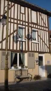 a building with a bench in front of it at Meublé de tourisme Le Gilliard in Chavanges