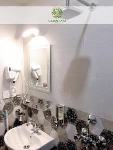 a bathroom with a sink and a mirror at Green Tara Homestay in Gangtok