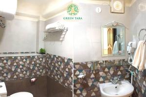 a bathroom with a sink and a toilet and a mirror at Green Tara Homestay in Gangtok