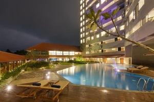 a swimming pool in front of a building at night at Apartment Universal in Galle