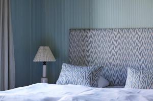 Un ou plusieurs lits dans un hébergement de l'établissement Rye115 Hotel